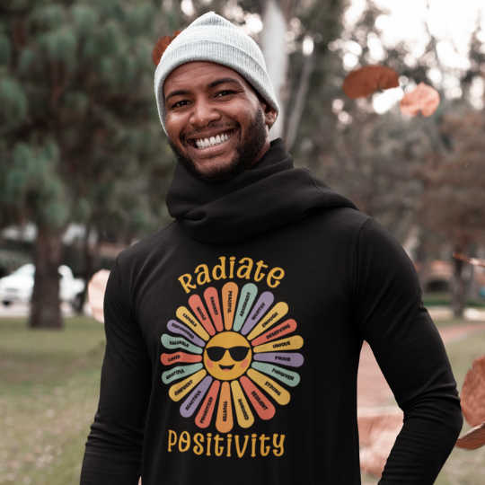 Trippy Outfitters - Motivation Collection - "Radiate Positivity" T-shirt featuring a cheerful sun with sunglasses and colorful beams filled with empowering affirmations.